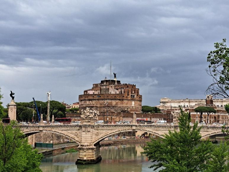 A bridge over a river with a large round building