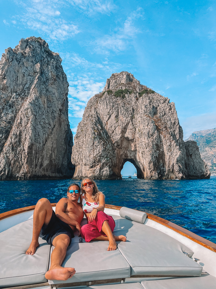 Enjoying our private boat cruise in Capri, with the iconic Faraglioni Rocks behind us - one of the highlights of our Capri day trip