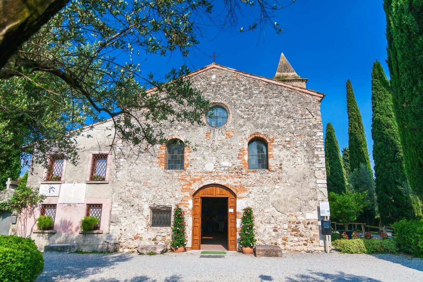 The stone front facade of San Pietro in Mavino, the oldest church in Sirmione, Italy