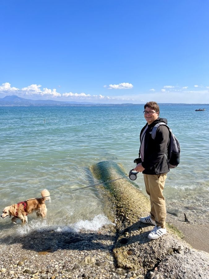 Jeremy Storm and Ranger Storm standing by the water at a Sirmione beach, Lake Garda