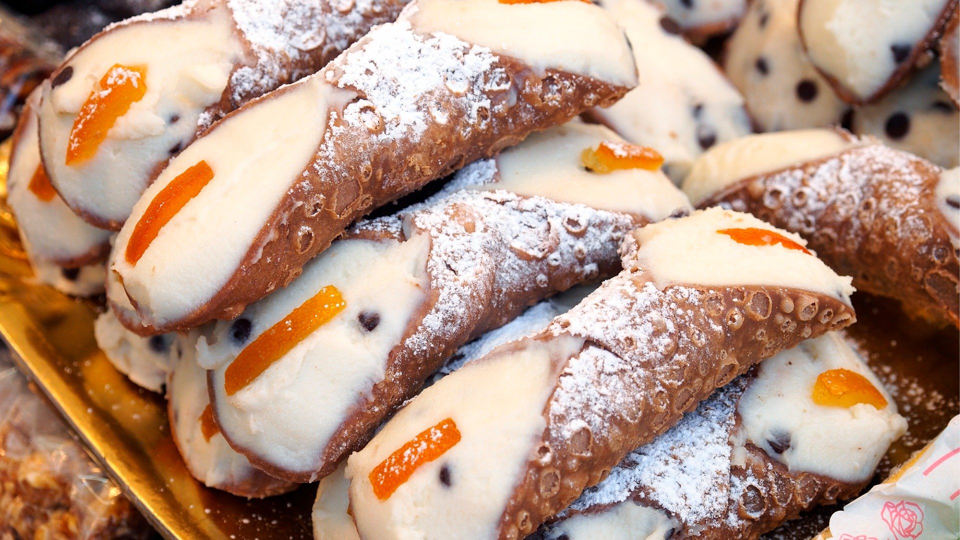 A close up of a pile of cannoli.