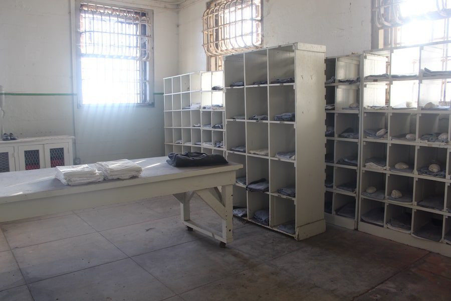 Alcatraz prisoner uniforms organized in cubbies.