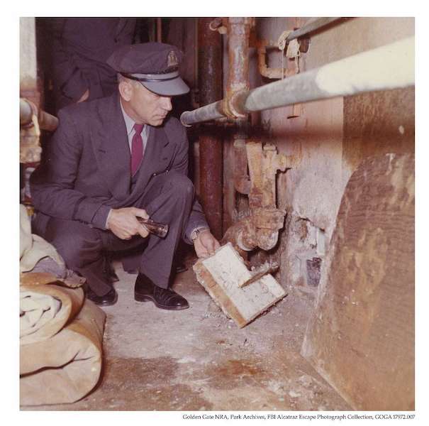 Alcatraz correctional officer investigating the 1962 escape in the utility corridor.