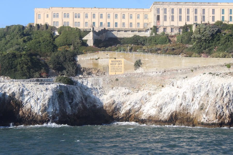 Warning sign at the entrance of Alcatraz Island. 'WARNING. Persons attempting to come inside the buoys without permission, do so at their own peril.'