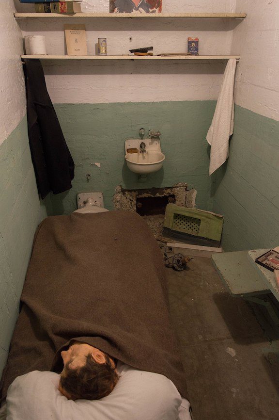 Alcatraz prison cell Frank Morris escaped from, with a replica of the head found peeking out from under the covers.