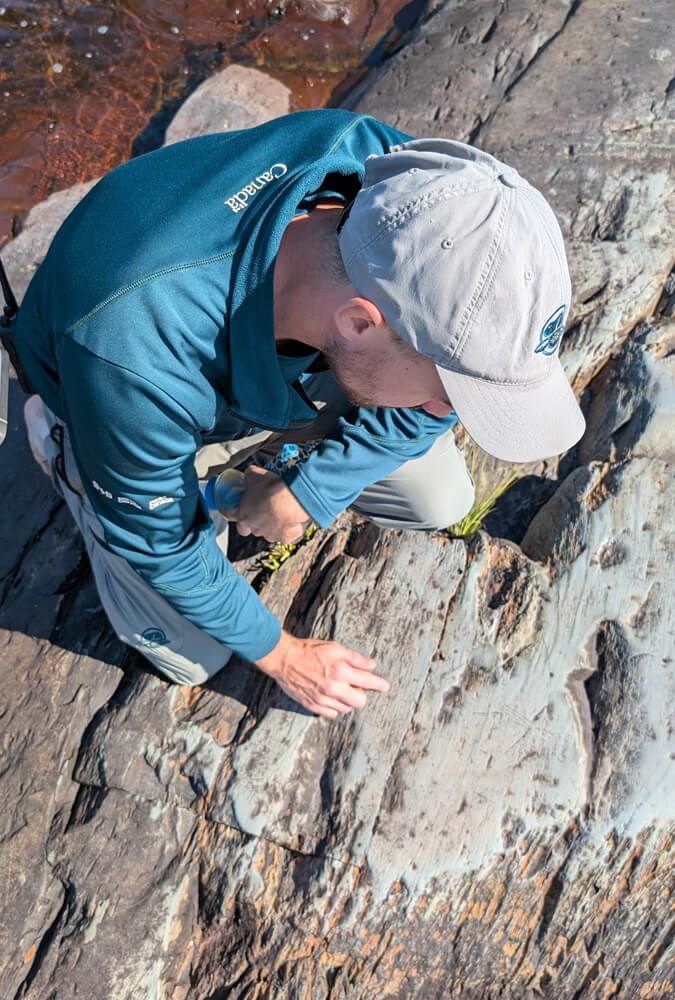 Parks Canada Interpreter Pointing out Petroglyphs in Kejimkujik National Park :: I've Been Bit! Travel Blog