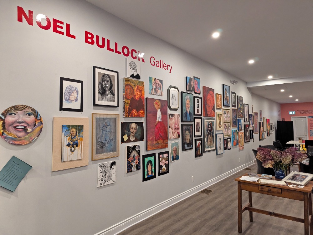 Noel Bullock Gallery in Gananoque. With a variety of pieces of art along the wall.