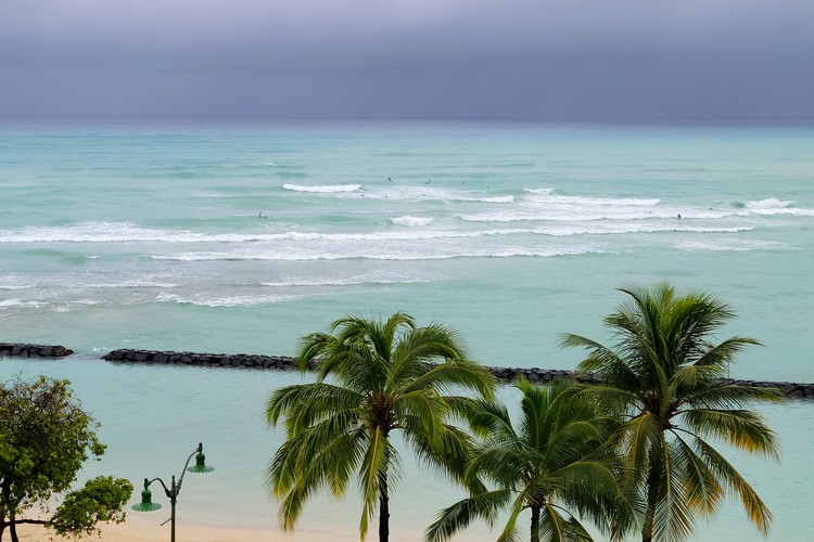 Surfers at Waikiki Beach during a storm, Oahu, Hawaii