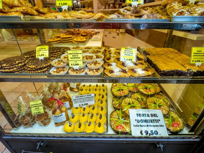 Pastries displayed with their corresponding prices in an Italian bakery