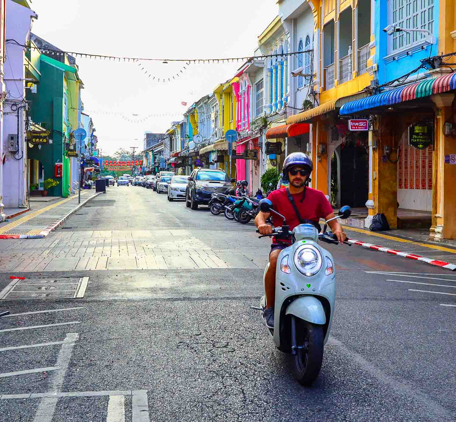 Phuket old town colourful streets driving with a scoopy in Thailand