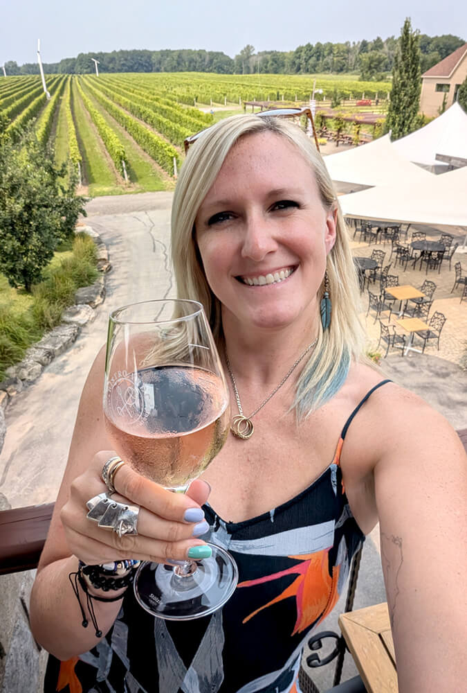 Lindz Holding a Glass of Wine at Vignoble Rivière du Chêne :: I've Been Bit! Travel Blog