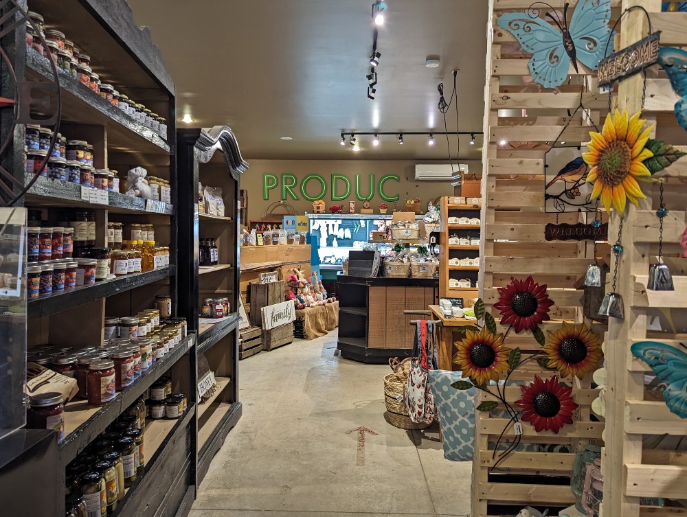 Hewitt’s Farm Market with shelves lined with preserves, fresh produce, and home decor