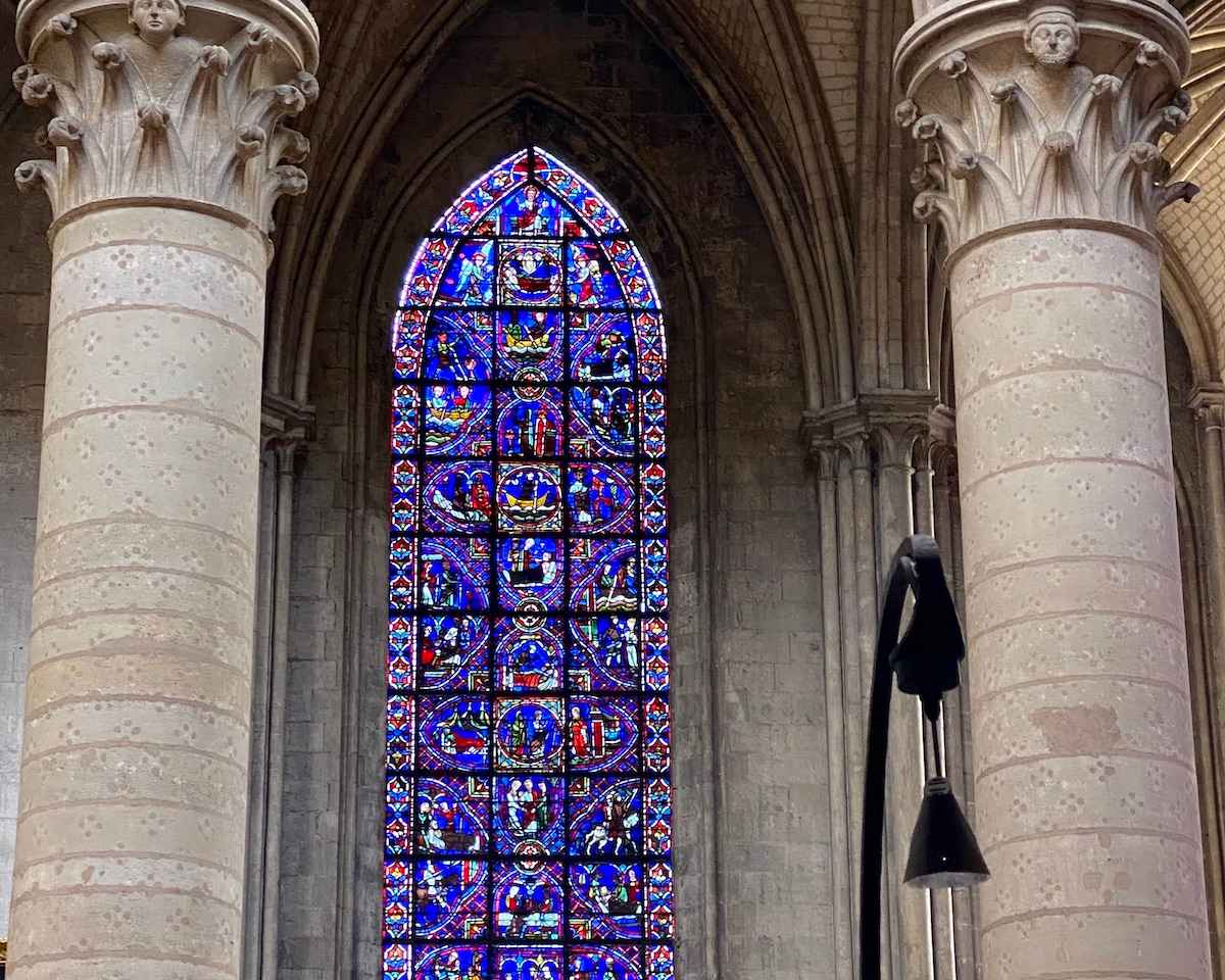 Stained glass windows with Gothic pillars in Rouen Cathedral.