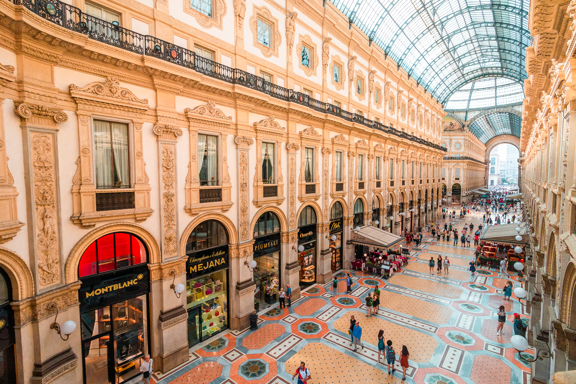 Panoramic view of the interior of Galleria Vittorio Emanuele II in Milan, one of the best places to visit in Italy.