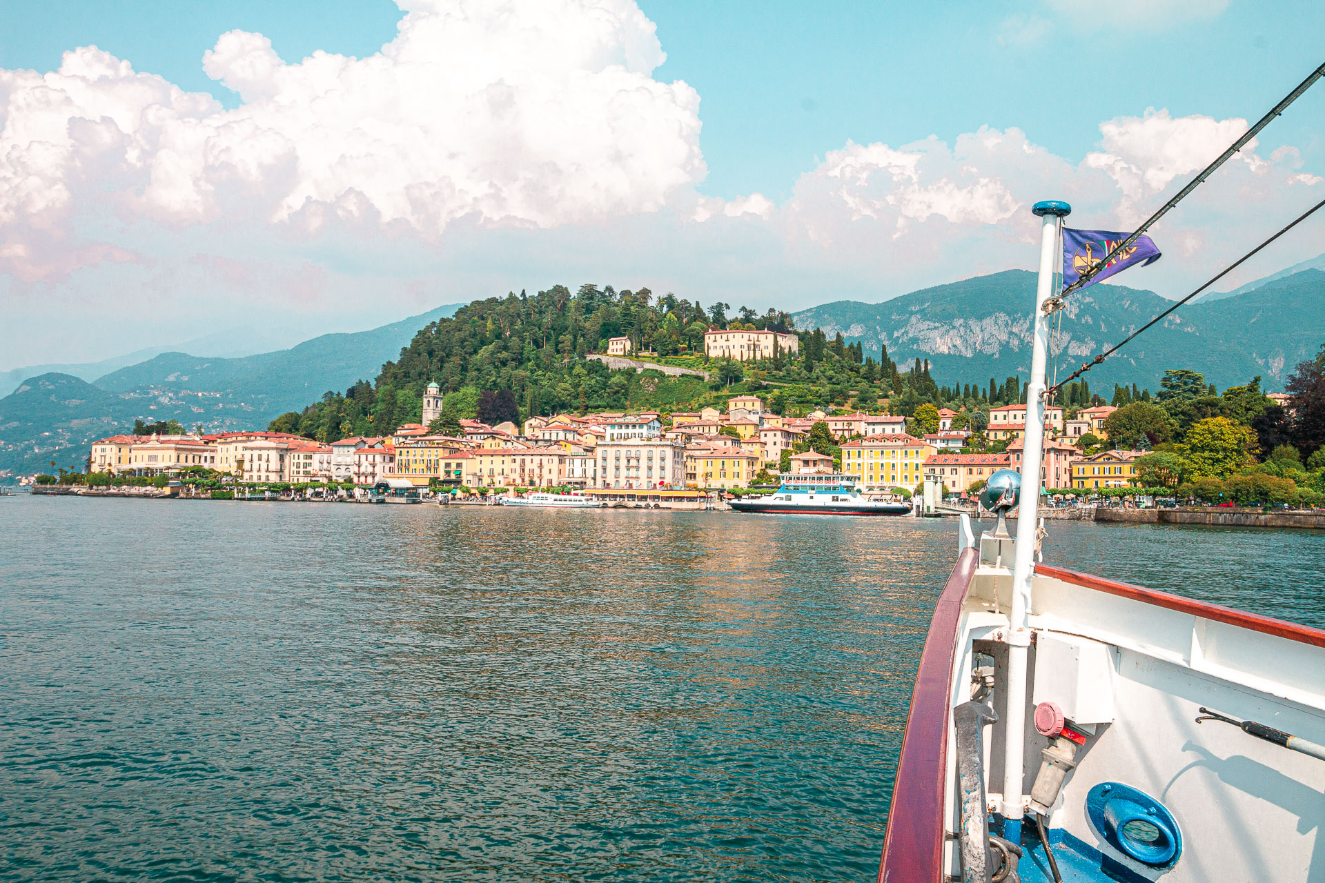 A boat approaching a quaint town on the shores of Lake Como, one of Italy's greatest destinations.