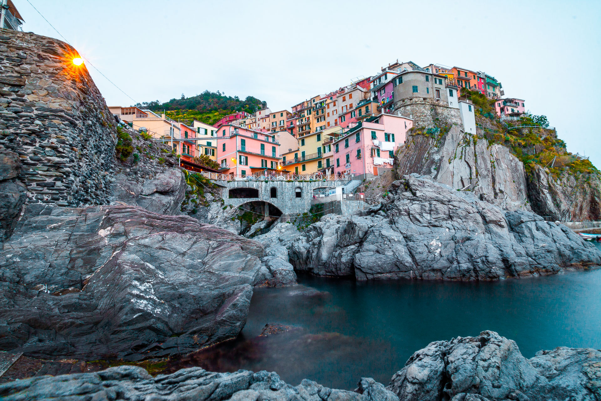 A vibrant village perched atop dramatic grey cliffs in Cinque Terre. 