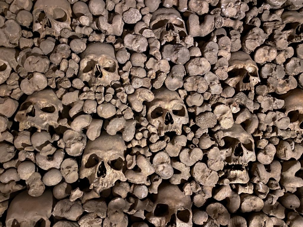 Skulls and bones piled together in the ossuary of Brno, Czech Republic