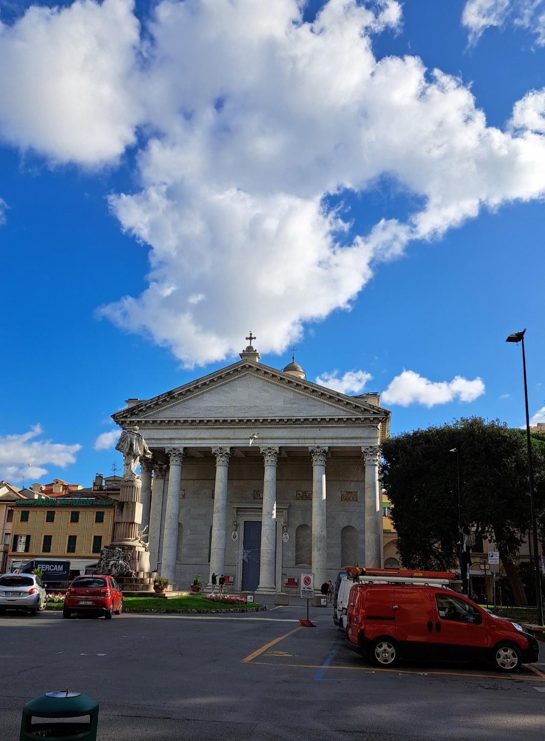 A building with columns and a cross on the top