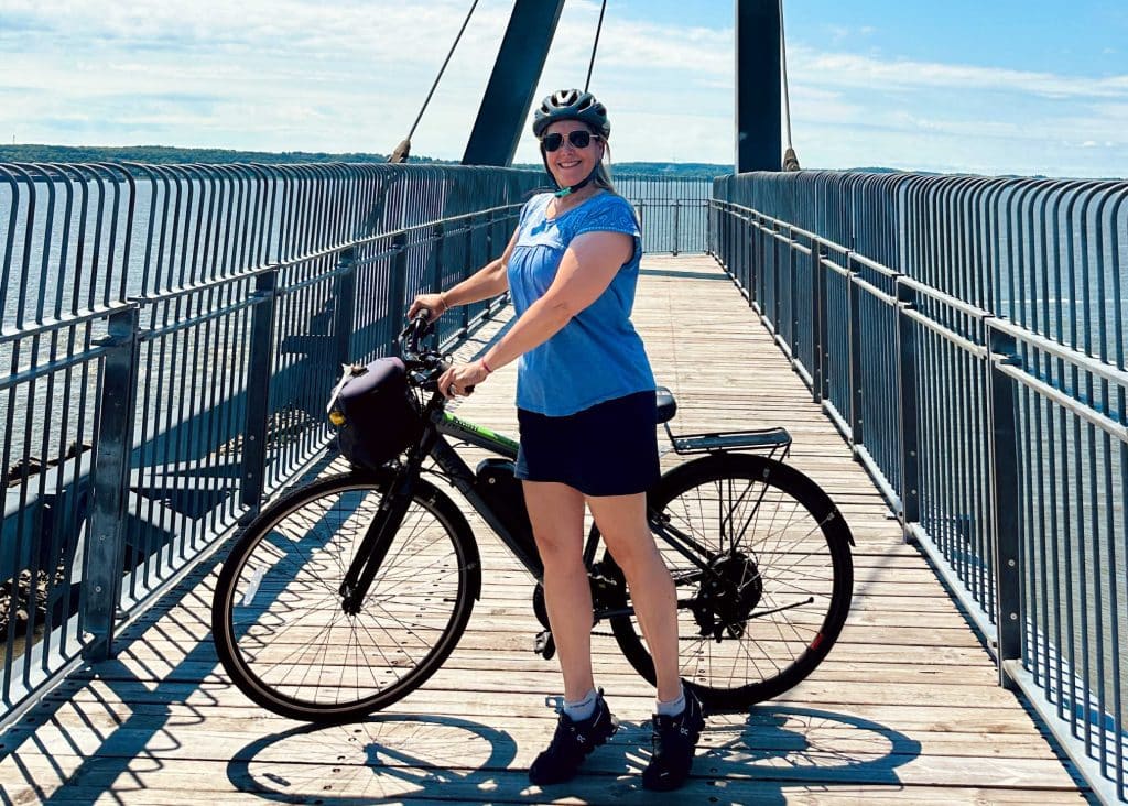 lady in blue cycling in quebec city in summer