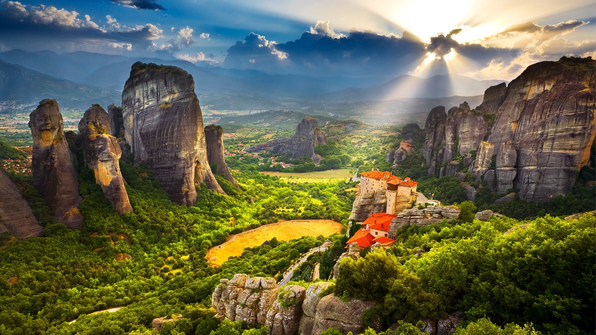 A panoramic view of the Meteora rocks during sunset.