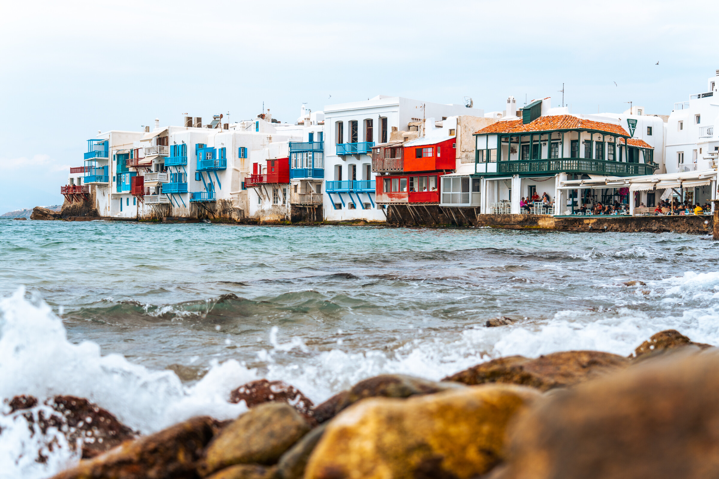 Little Venice in Mykonos, lined with colorful houses perched on the sea's edge.