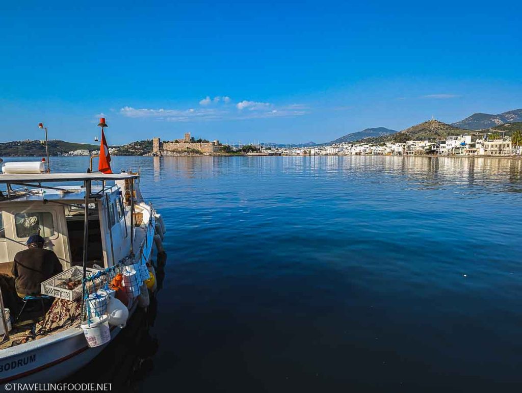 Boat with landscape of The Castle of St Peter and mountains in Bodrum, Turkiye