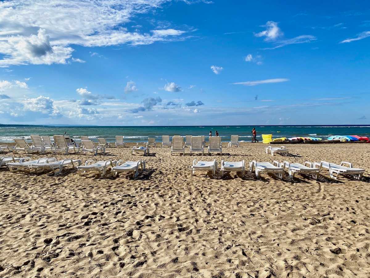 Blue Mountain Village Private Beach with deck chairs on the sand.