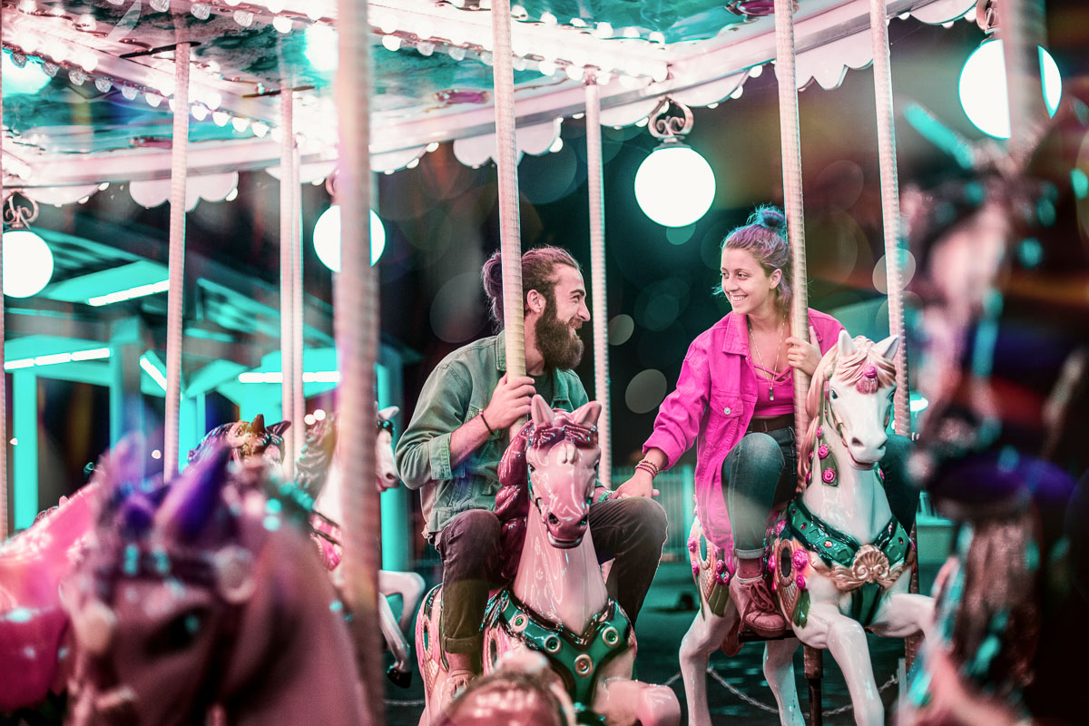 Couple enjoying date night on a merry-go-round