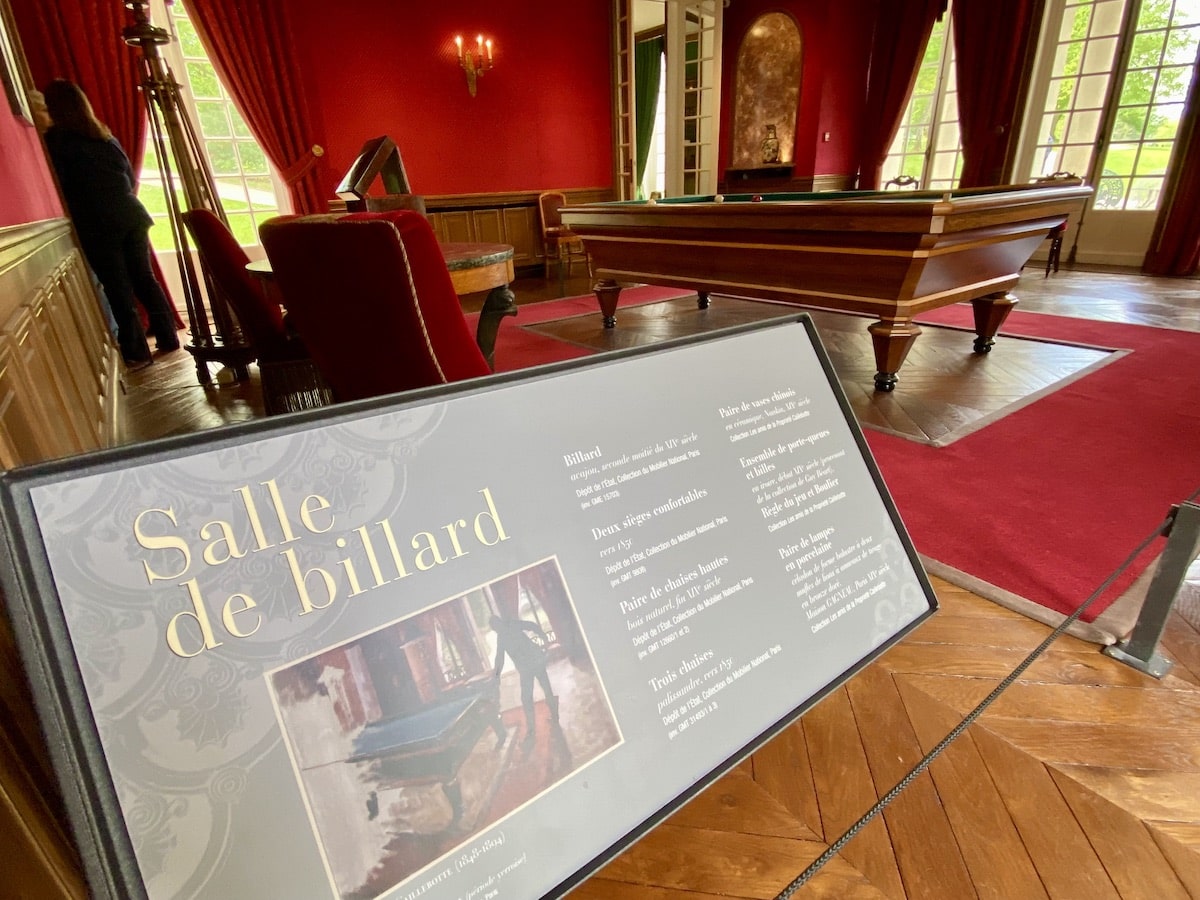 Billiard room decorated in rich red tones.