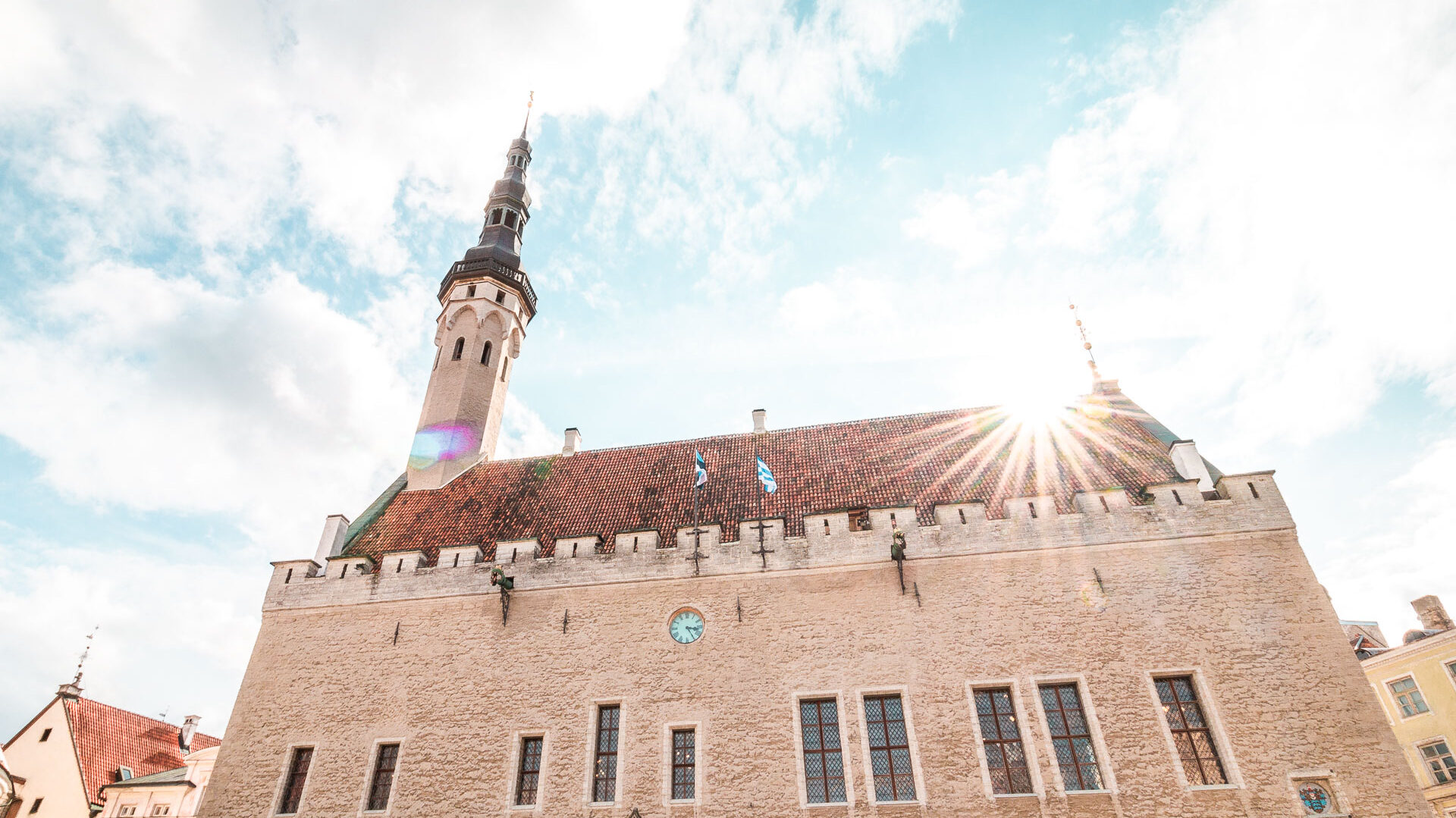 This is a close-up of a red-tiled roof building under a vibrant sky.