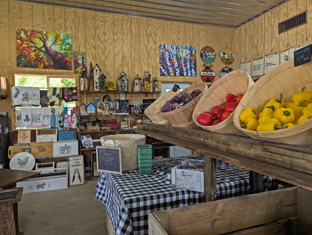 Inside Tindall Farm & Market displaying fresh vegetables and artisanal products.