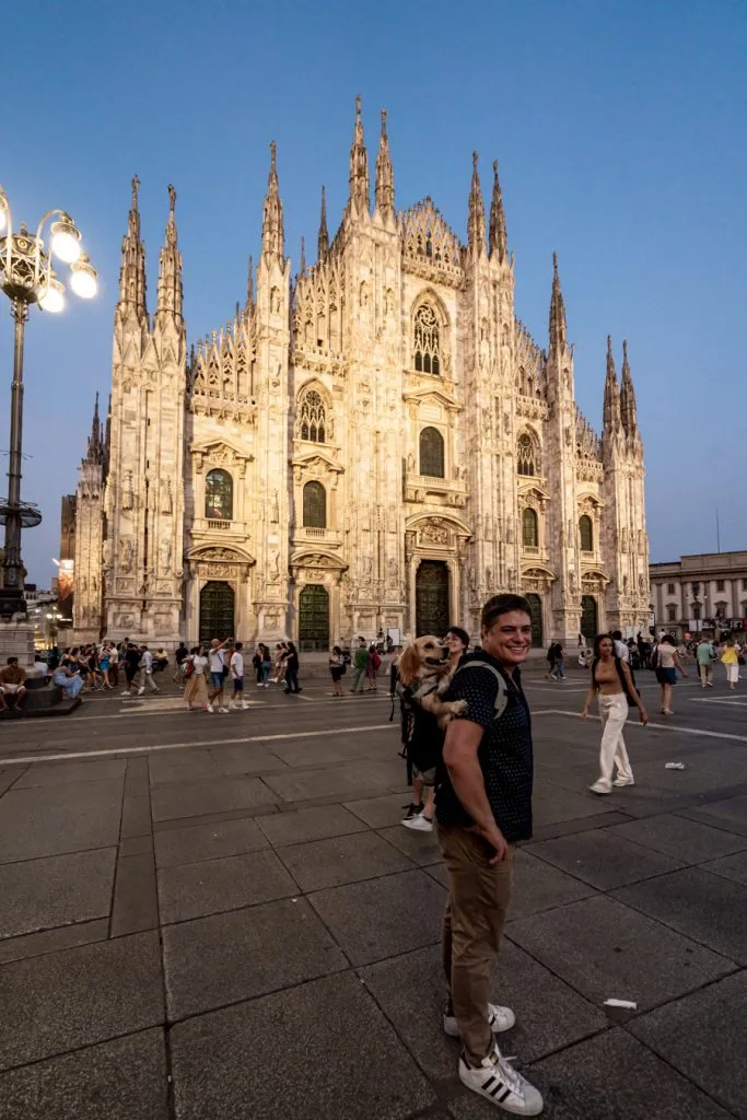 A family in front of the Milan Duomo at night