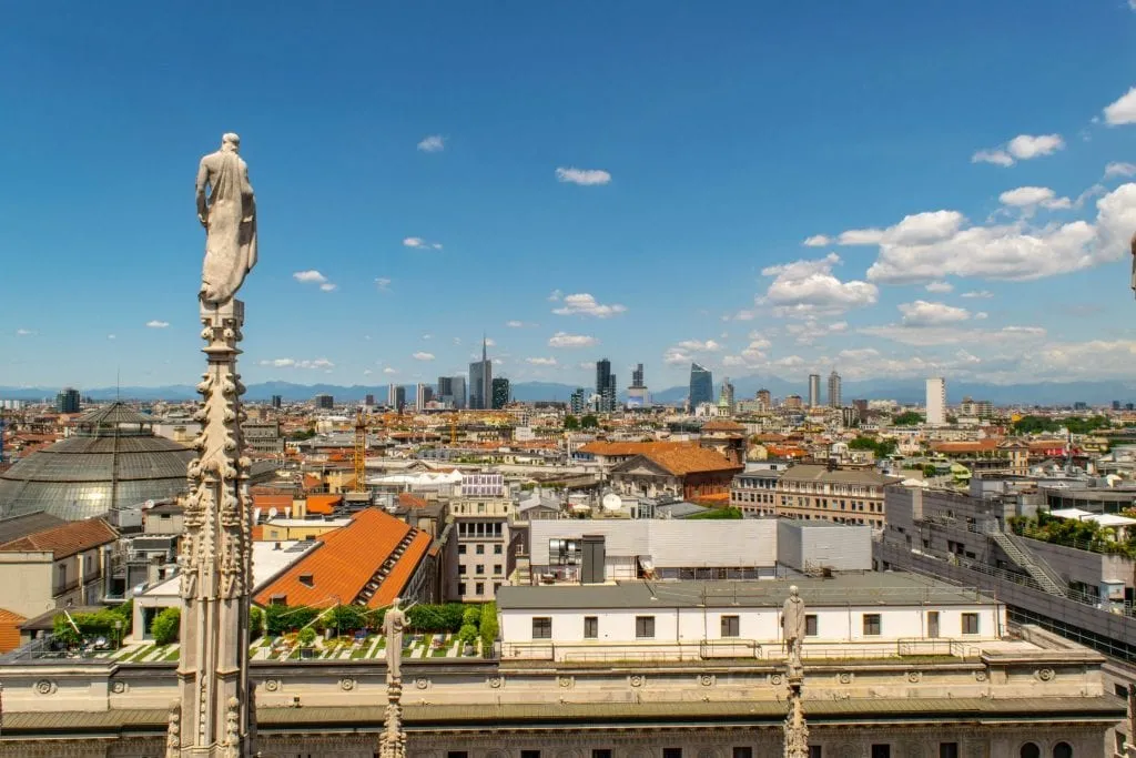 View of the modern Milan skyline with the cathedral spire in the foreground