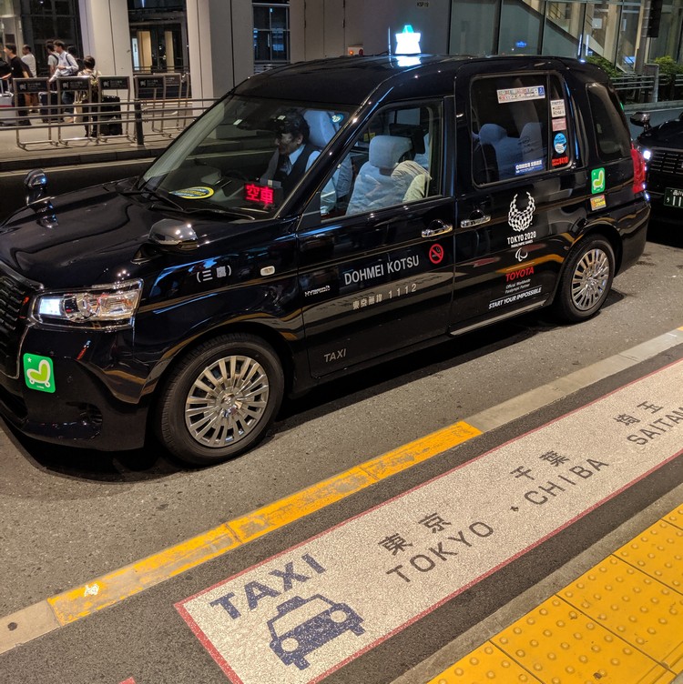 black airport taxi waiting outside at the Tokyo Haneda Airport in Tokyo Japan