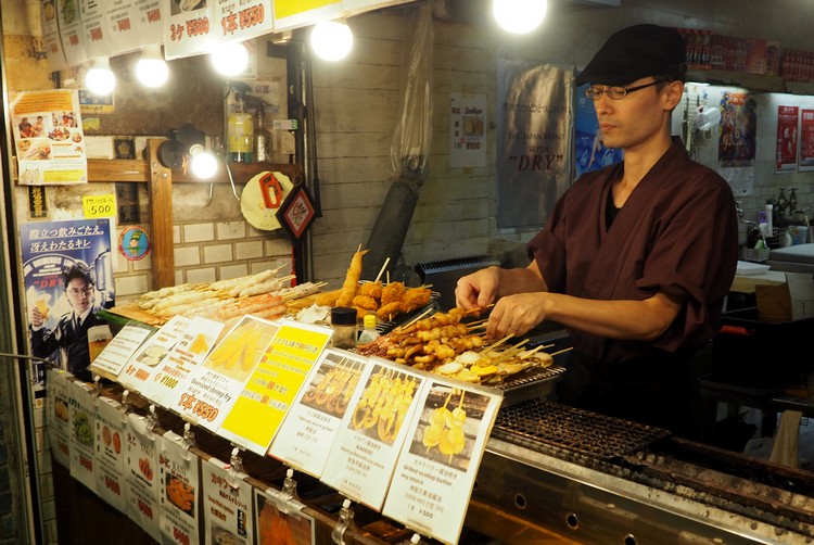 grill yakitori meet sticks at market on streets of Tokyo Japan travel tips