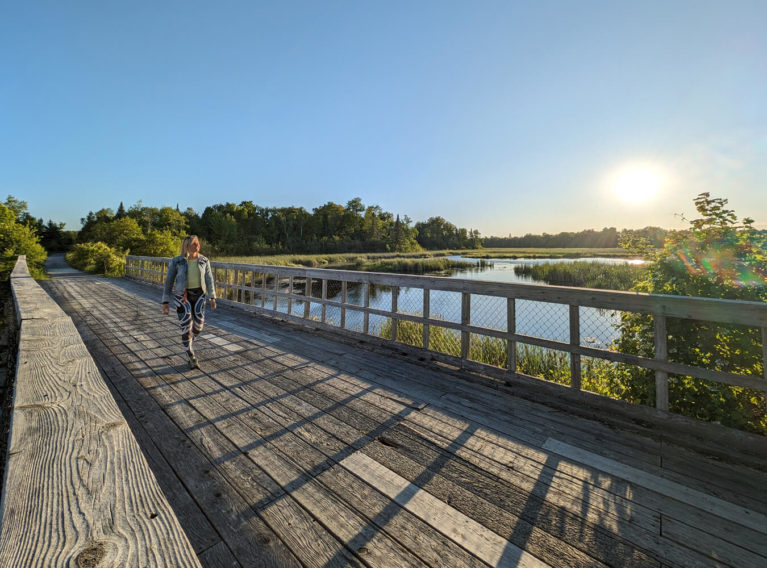 Lindsay Walking Over the Bridge Beside the Beaver River :: I've Been Bit! Travel Blog