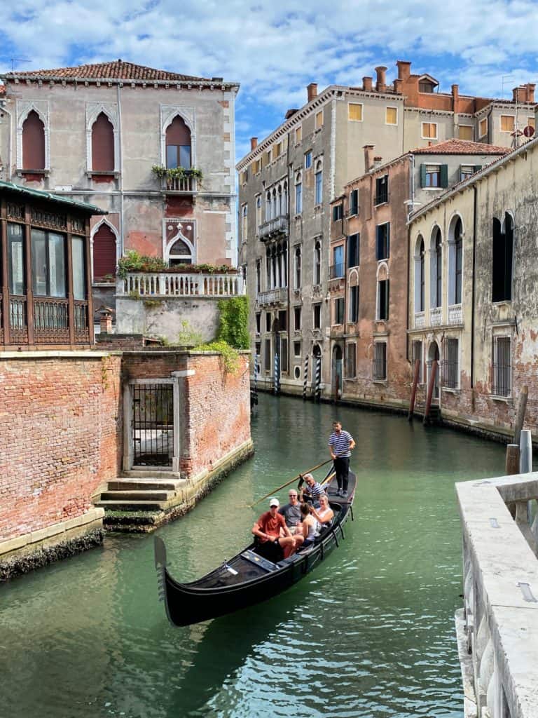 Gondola on green water in Venice