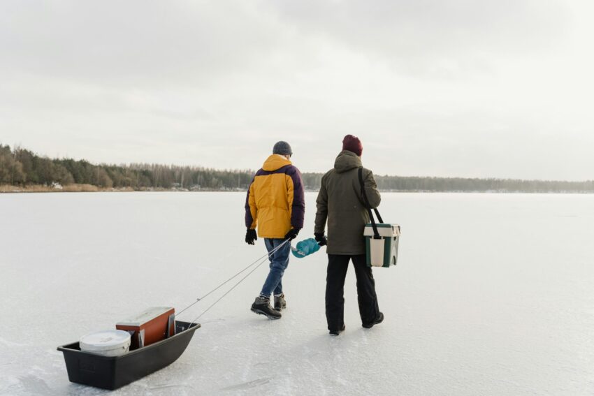 Men walking on a frozen lake with exploration tools