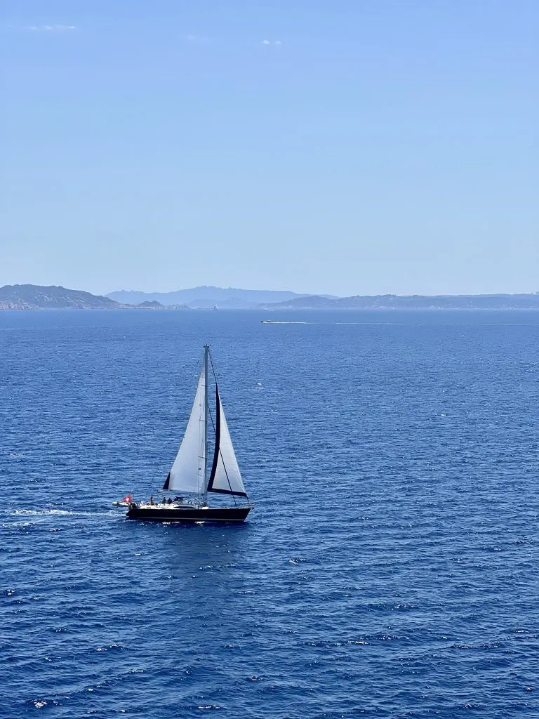 View of a sailboat on the Mediterranean Sea, seen while taking a ferry from Barcelona to Rome