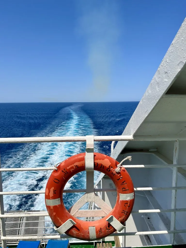 View of an orange life preserver and the back of the Grimaldi Lines boat on the Mediterranean Sea