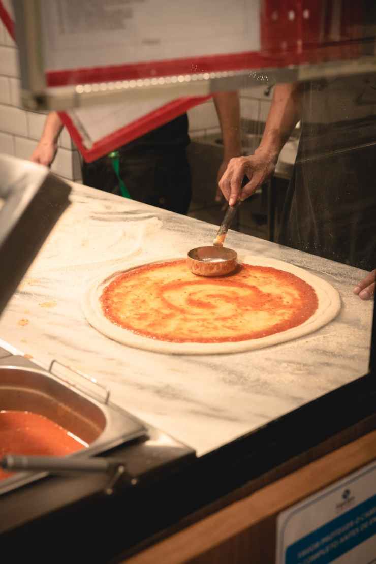 Photo of person making pizza