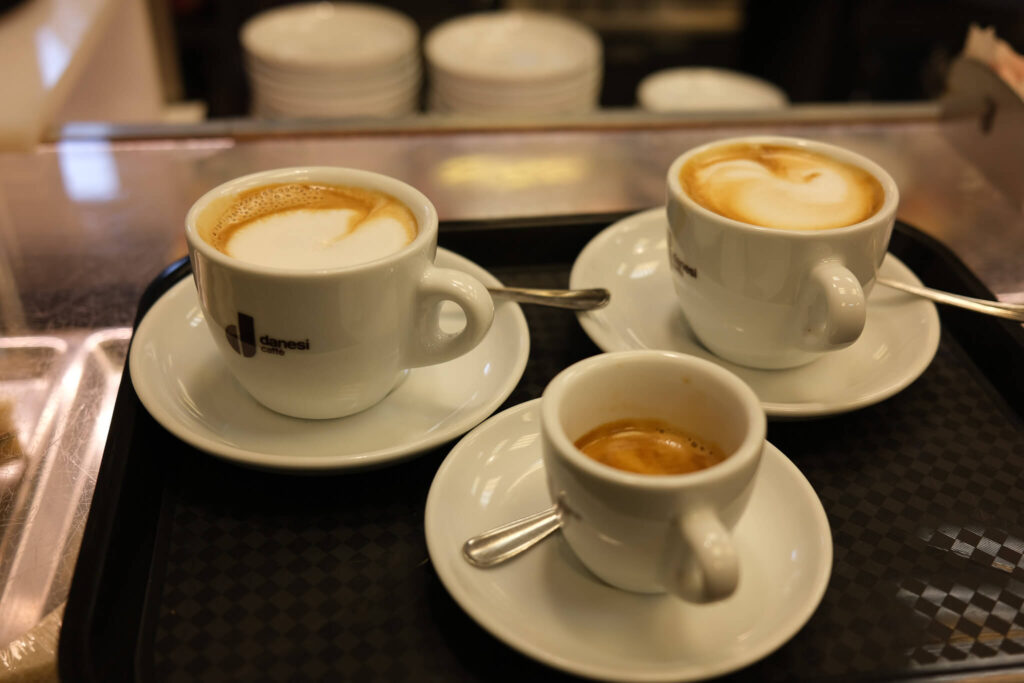 Two types of Italian coffee displayed at the bar: caffè and cappuccino.