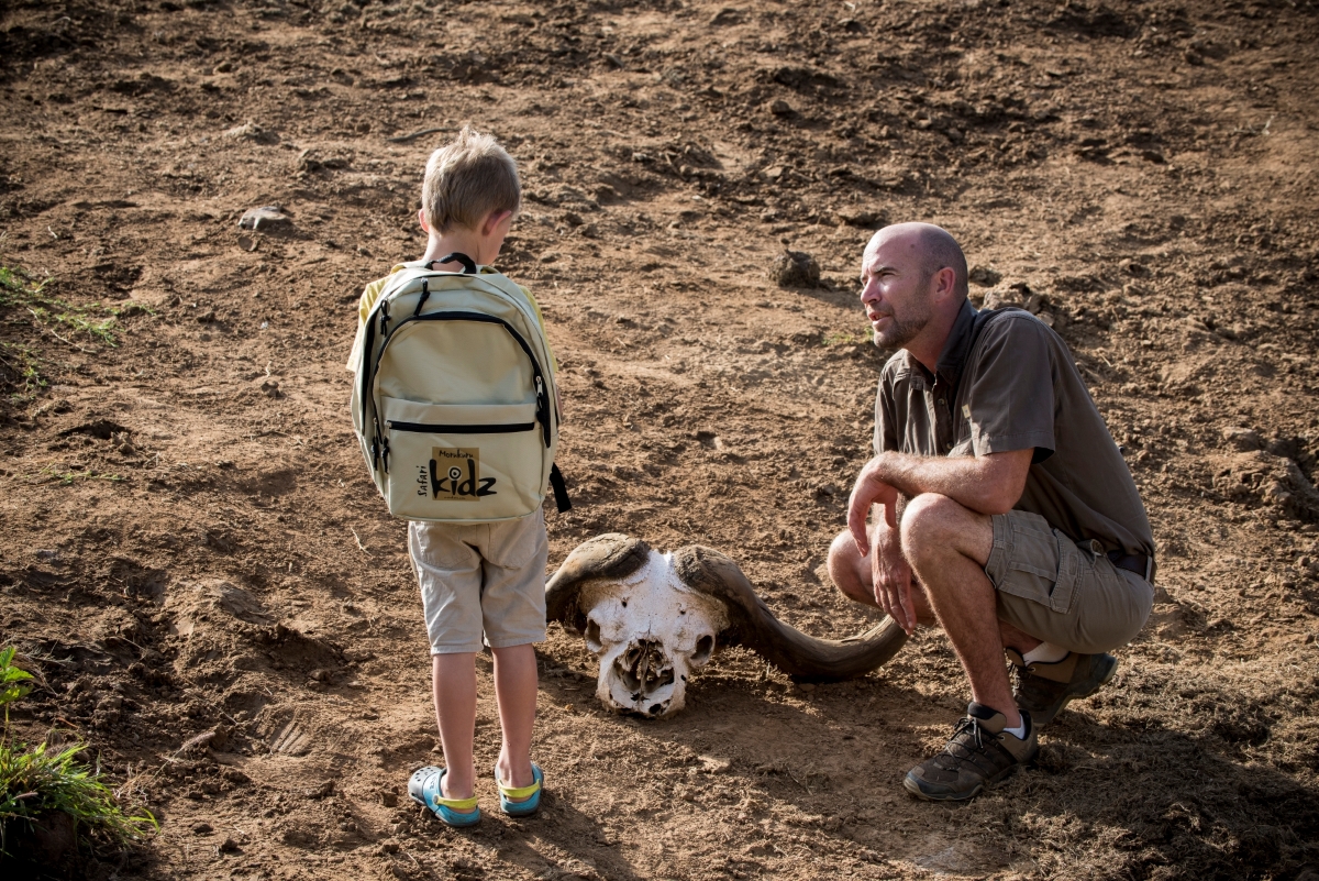 Child-friendly lodges: Madikwe's guide teaching child about the wilderness