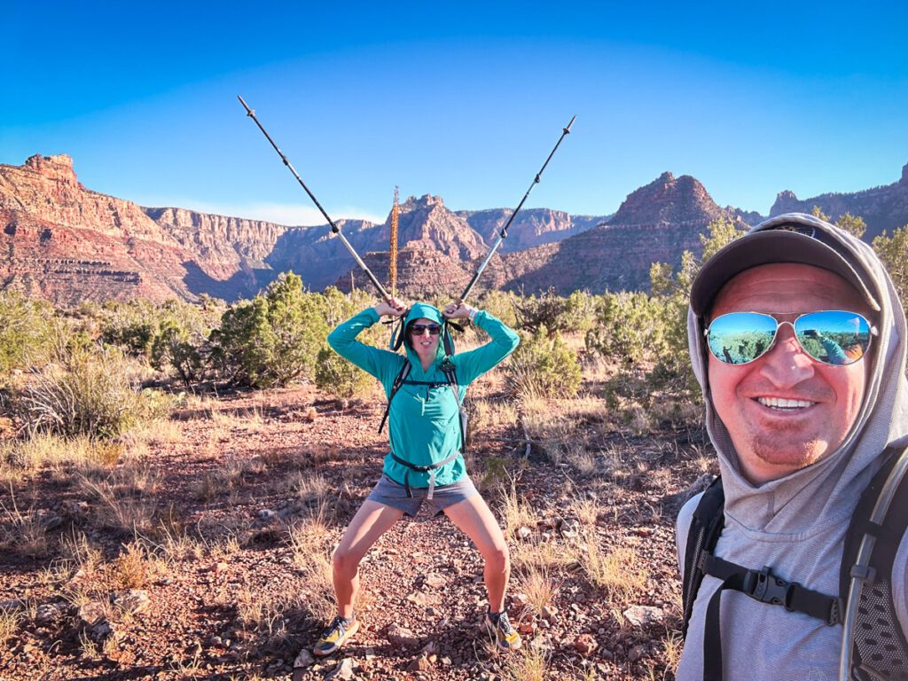 Two people backpacking in the Grand Canyon using hiking poles.