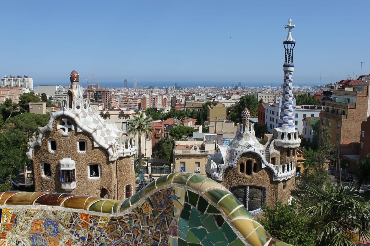 View from Parc Güell in Barcelona showcasing Gaudi's whimsical sculptures and buildings.