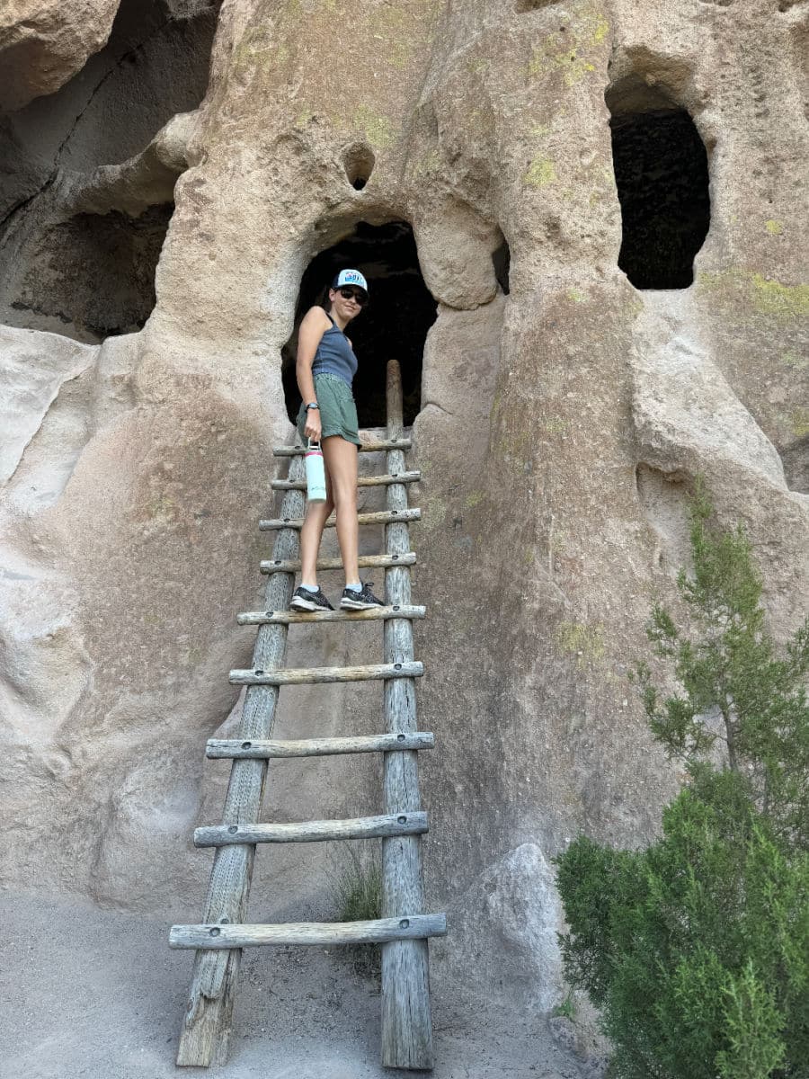 Climbing a ladder at Bandelier National Monument