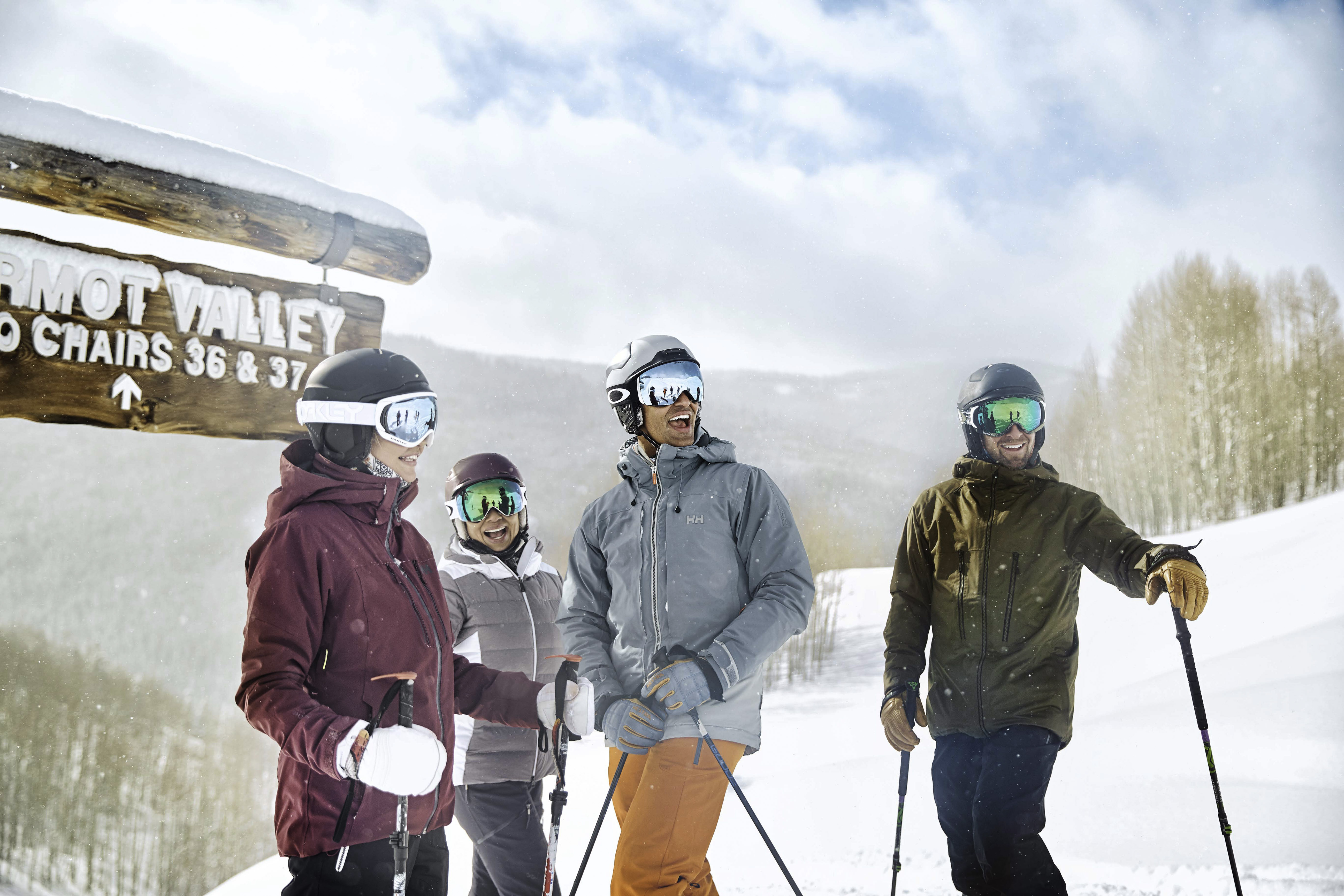 Family dressed for skiing with proper gear from their ski trip packing list