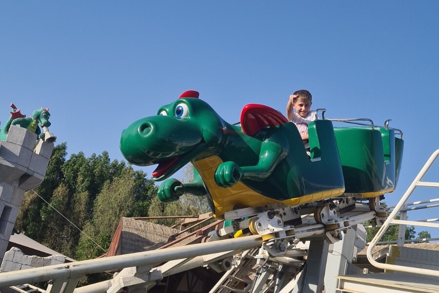 Dragon's Apprentice mini roller coaster ride at Legoland Dubai young boy riding alone