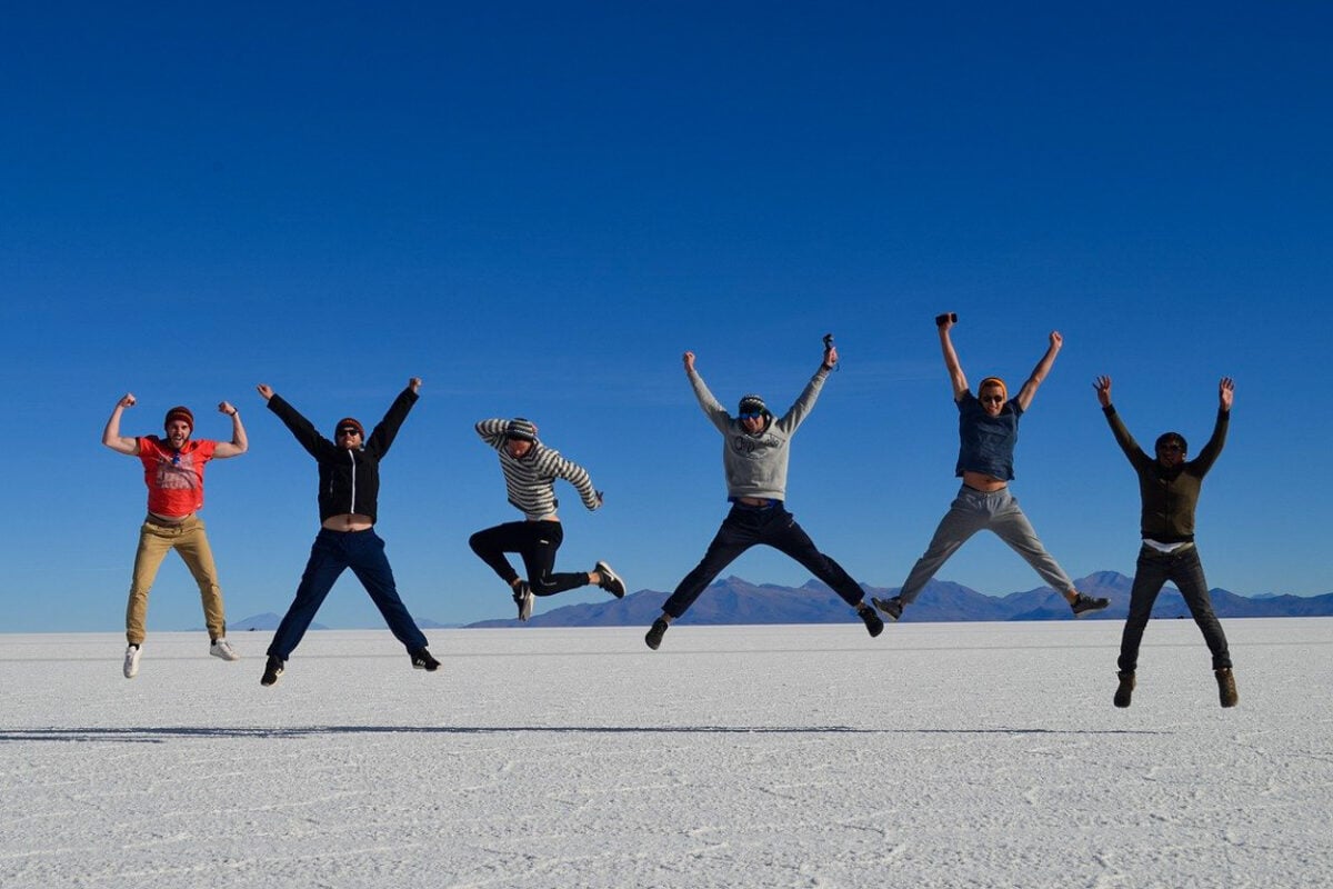 Backpackers jumping at salt flats