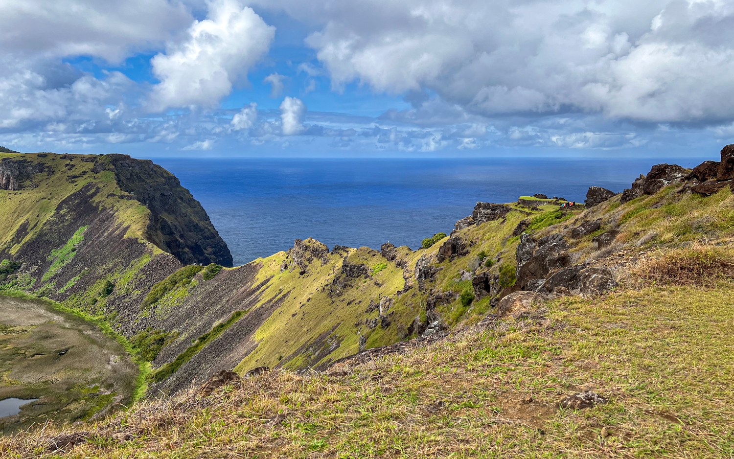 The Rano Kau crater rim on Easter Island, with visitors to Orongo seen in the center-right.